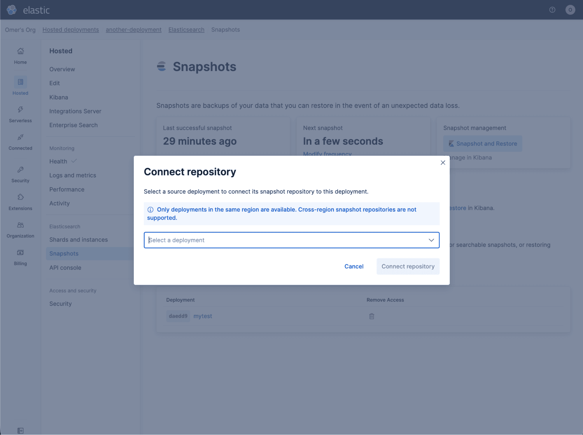 Elastic Cloud interface showing the Snapshots page with a modal titled “Connect repository.” The modal includes a line: "Select a source deployment to connect its snapshot repository to this deployment." And the modal has a dropdown labeled “Select a deployment,” a note stating that only same‑region deployments are supported, and buttons for Cancel and Connect repository.